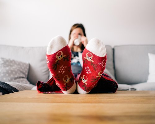 Person adjusting lighting in a cozy living room